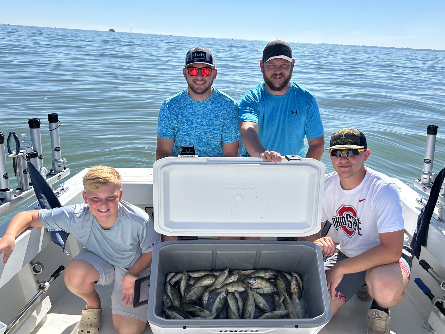 Guests displaying their catch during a Reel Therapy Sportfishing charter on Lake Erie
