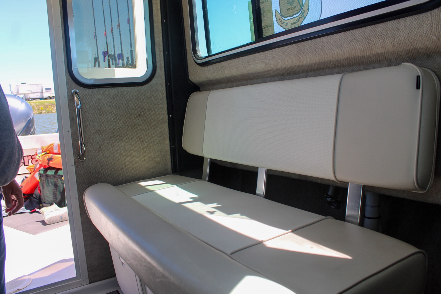 Cushioned passenger bench inside the enclosed Parker pilothouse